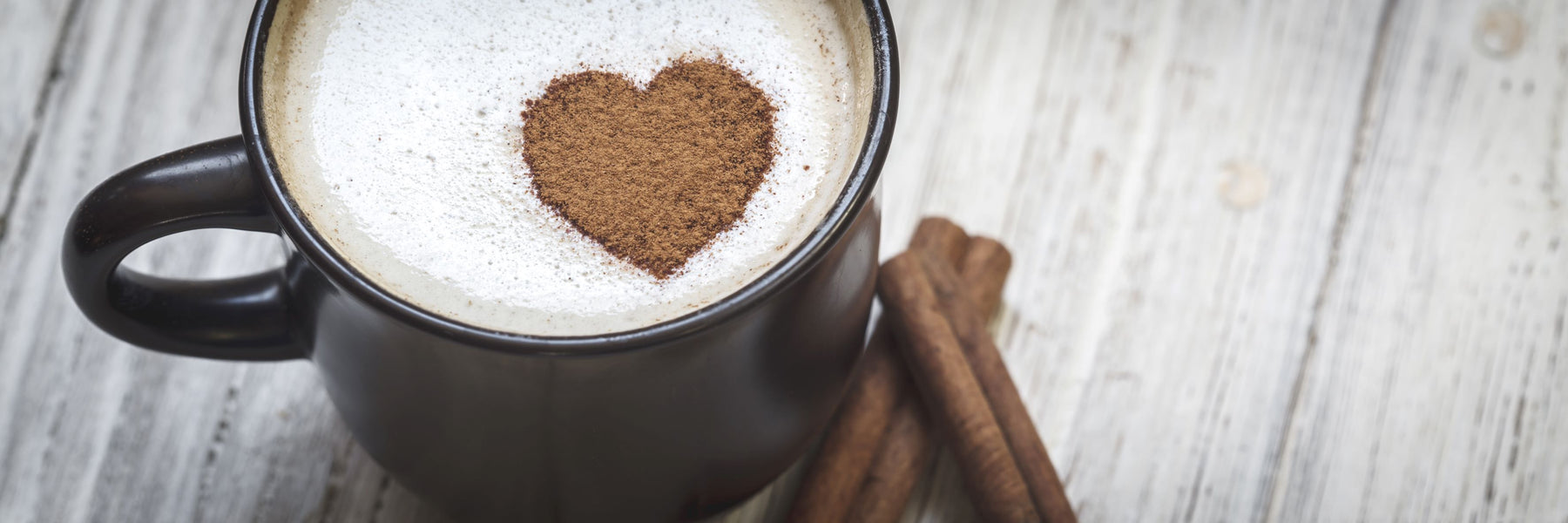 A warm cup of coffee with a heart design